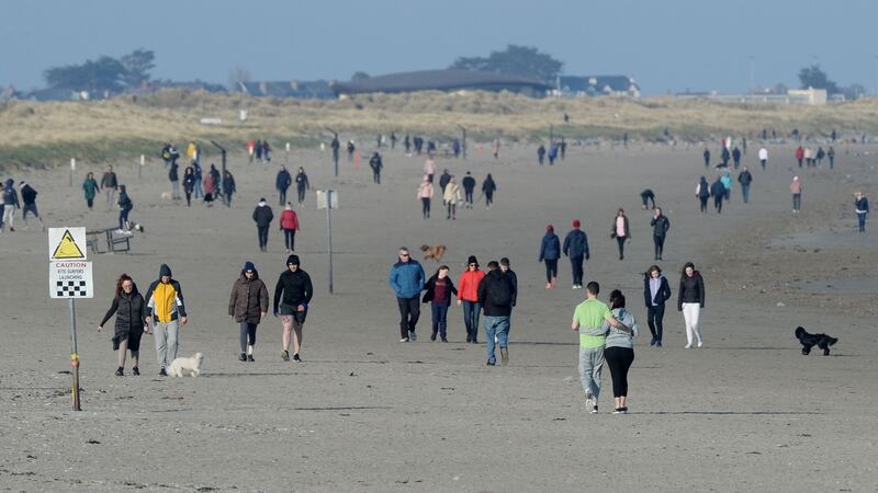 Warnings over social distancing were repeated on Sunday after many people visited beaches, seaside towns and the mountains for a day out. Above, walkers on Dollymount beach in Dublin. Photograph: Alan Betson/The Irish Times