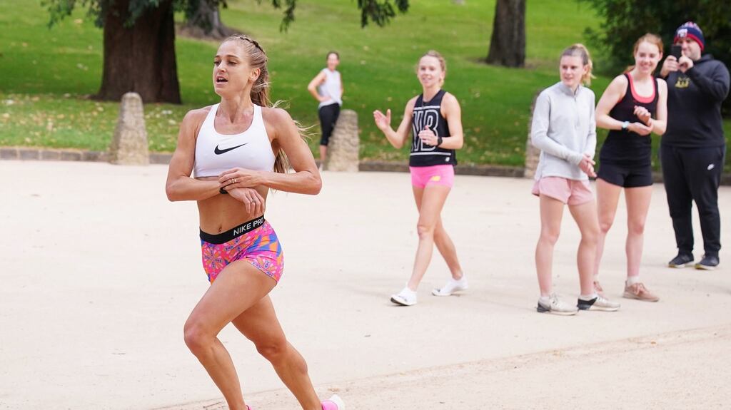 Australian Olympic athlete Genevieve Gregson breaks the long-standing record to become the fastest woman to run a lap of The Tan track in Melbourne. Photo: Michael Dodge/EPA
