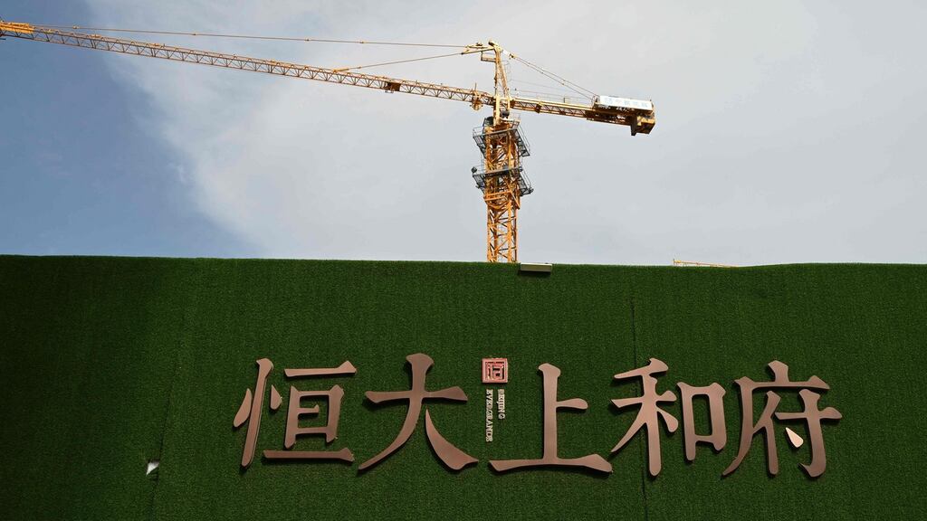 The Evergrande name and logo are seen outside the construction site of an Evergrande housing complex in Beijing