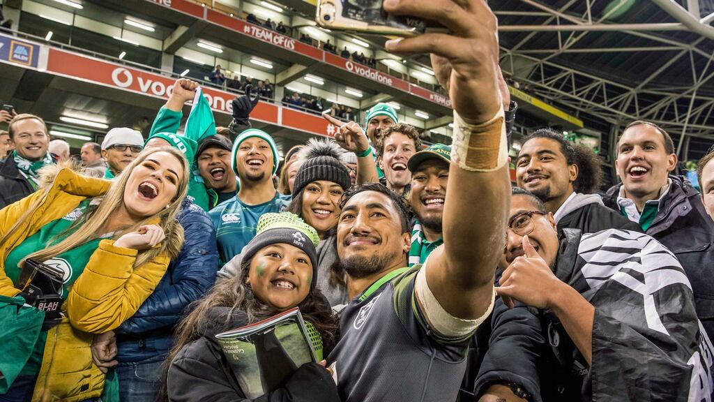 Ireland’s Bundee Aki takes a picture with his six-year-old daughter Adrianna and members of the extended Aki family after the victory over South Africa at the Aviva. Photograph: Morgan Treacy/Inpho