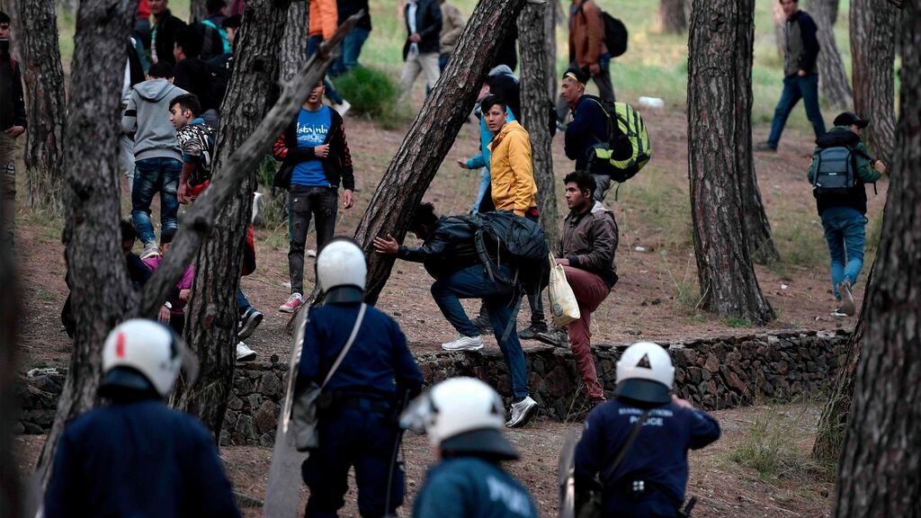 Migrants run from riot police after being pushed to go back to Moria camp from the port of Mytilene, on the island of Lesbos on Tuesday. Photograph: Getty Images
