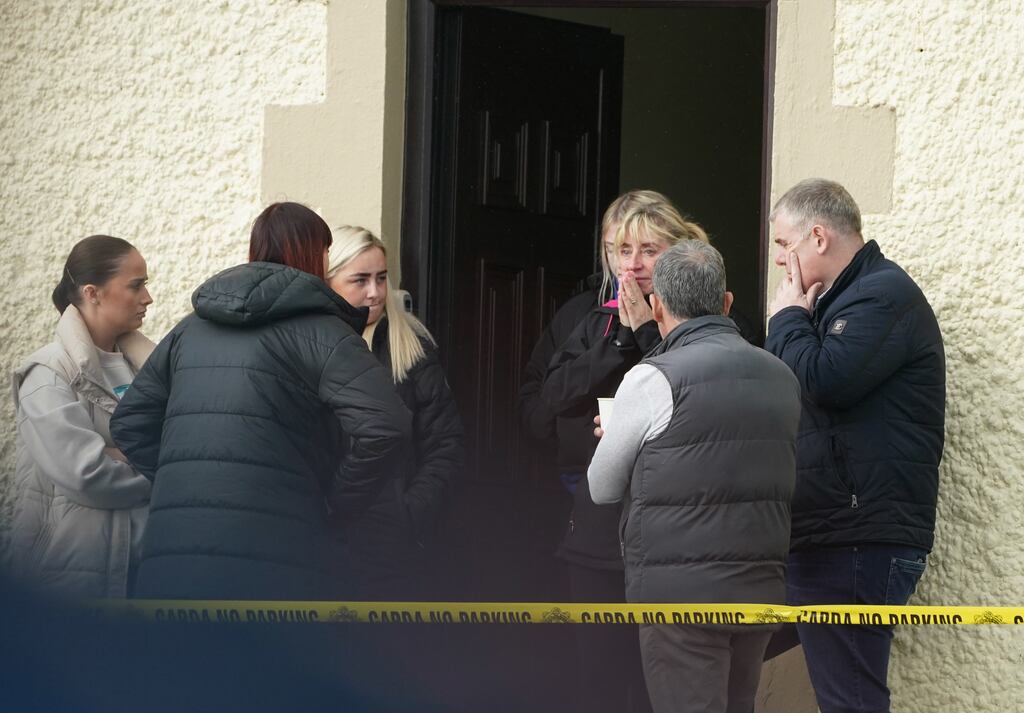 People gather by nearby damaged buildings in Creeslough, Co Donegal on Saturday. Photograph: Brian Lawless/PA