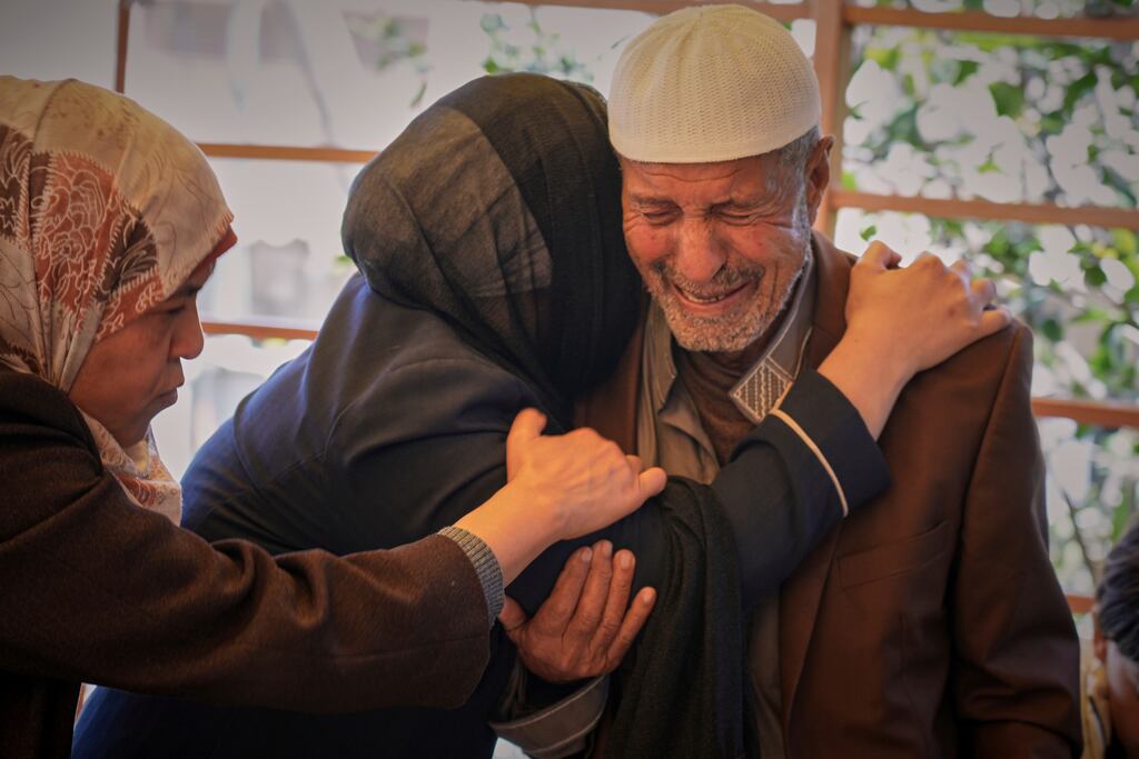 Hassan Abu Sultan mourns over the body of his son Jehad, who, along with his wife and three children, was killed when an Israeli army strike hit their tent at a hospital in Khan Younis. Photograph: Abdel Kareem Hana/AP