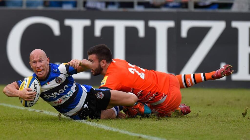 Scrumhalf Peter Stringer scores one of Bath’s seven tries  despite the tackle of Leicester’s Tommy Bell during their Aviva Premiership semi-final at the Recreation Ground. Photograph: Stu Forster/Getty Images
