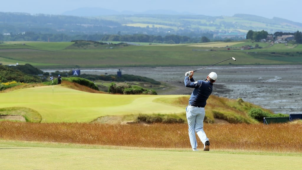 Graeme McDowell hits his third shot on the 18th hole during the first round of the Scottish Open at Castle Stuart Golf Links in Inverness. Photograph: Andrew Redington/Getty Images