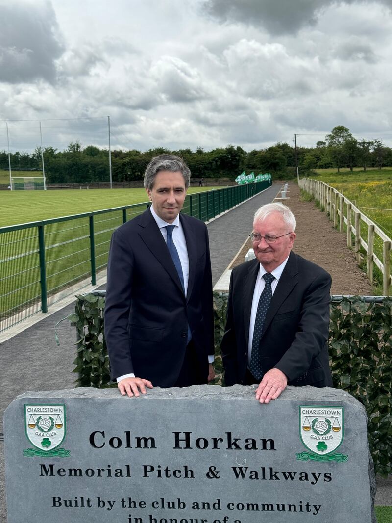 Taoiseach Simon Harris (left) with Detective Garda Colm Horkan's father Marty after he officially opening a new pitch and community walkways at Charlestown Sarsfields GAA Club in Co Mayo. Photograph: PA