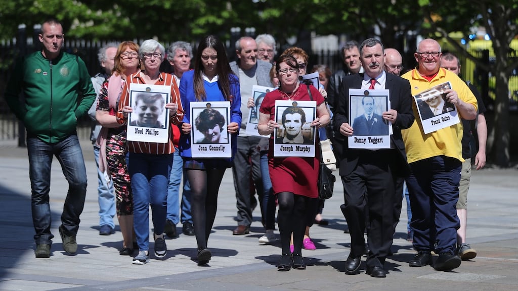 Families of those who died in the Ballymurphy Massacre hold images of the deceased outside Laganside Court in Belfast. Photograph: Niall Carson/PA Wire.