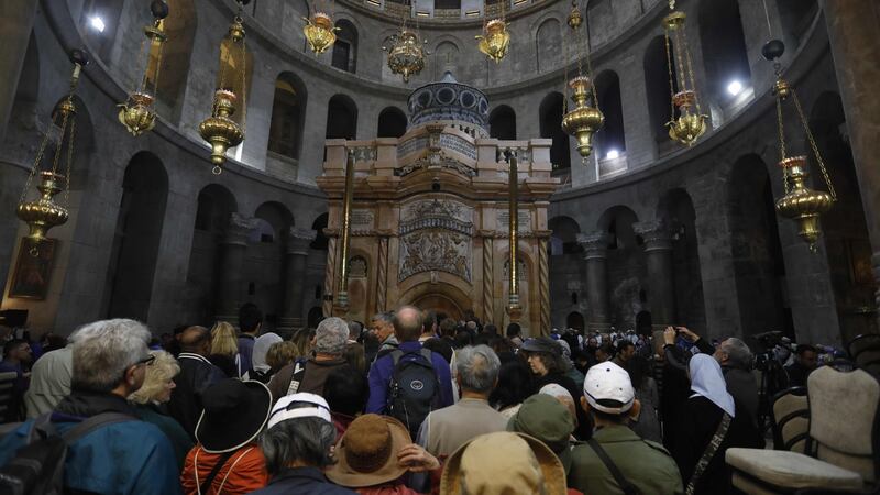 Tourists and worshippers wait to access the newly restored shrine surrounding what is believed to be Jesus’s tomb which was unveiled at a ceremony in Jerusalem on Wednesday following months of delicate work. Photograph: AFP/Getty Images