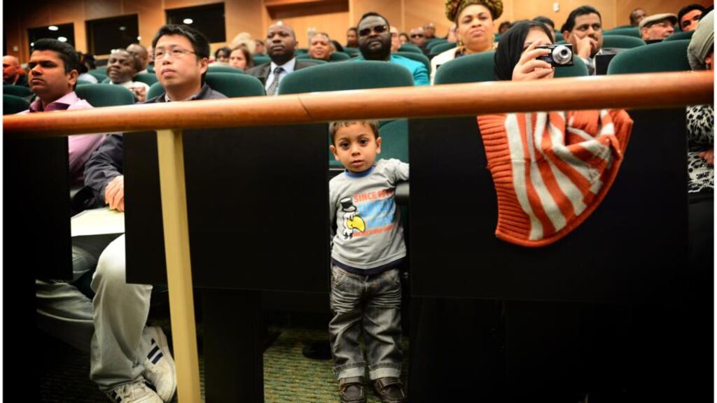 Mohammad Abu Alkhouu and his mother, Rajae Moawi (holding camera), at last month’s citizenship ceremony in Convention Centre Dublin, in which Irish citizenship was conferred upon 2,700 people. Photograph: Bryan O’Brien