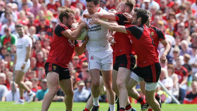Sean Cavanagh is the centre of attention for Down’s Gerard McGovern, Darren O’Hagan and Kevin McKernan during the Ulster football final at Clones. Photograph: Philip Magowan/Presseye/Inpho