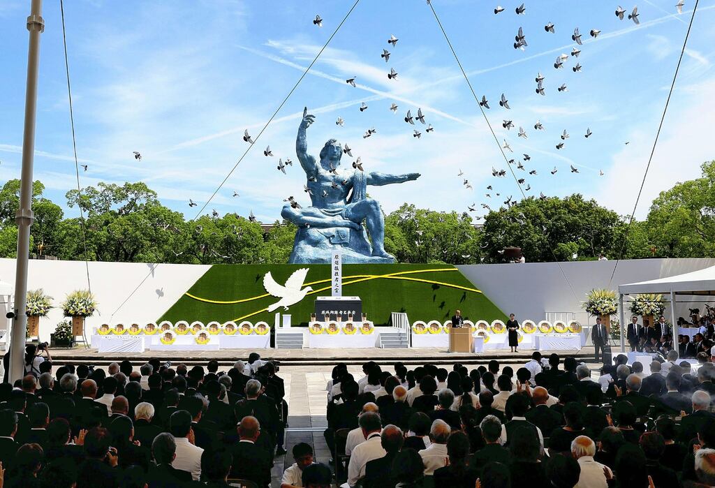 Doves fly over the Peace Statue during a ceremony marking the 79th anniversary of US atomic bombing that destroyed Nagasaki. Photograph: Jiji Press/EPA
