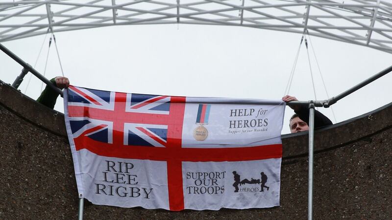 England fans hold a flag in memory of Drummer Lee Rigby prior to the International Friendly match between England and the Republic of Ireland at Wembley Stadium last night. A man is due in court charged with his murder today. Photograph:  Scott Heavey/Getty Images.