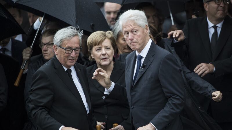 Former US president Bill Clinton, President of the European Commission Jean-Claude Juncker and German Chancellor Angela Merkel talk as they pay respect to late former chancellor Helmut Kohl at the cathedral in Speyer, Germany. Photograph: Maja Hitij/Getty Images