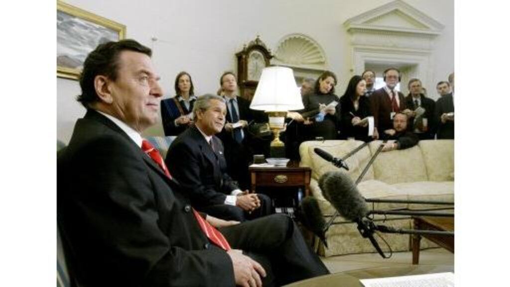 US President George W Bush hosts a meeting with German Chancellor Gerhard Schroder in the Oval Office of the White House, yesterday. Mr Schroder spoke of German concerns regarding the weakness of the dollar.