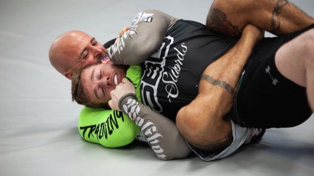 Aaron Burke grappling with his sparring partner