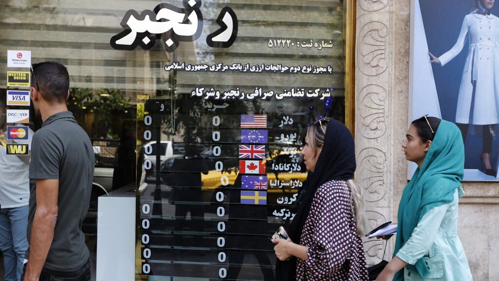 People outside a currency exchange shop in the Iranian capital Tehran. US president Donald Trump has warned the world against doing business with Iran. Photograph: Getty Images