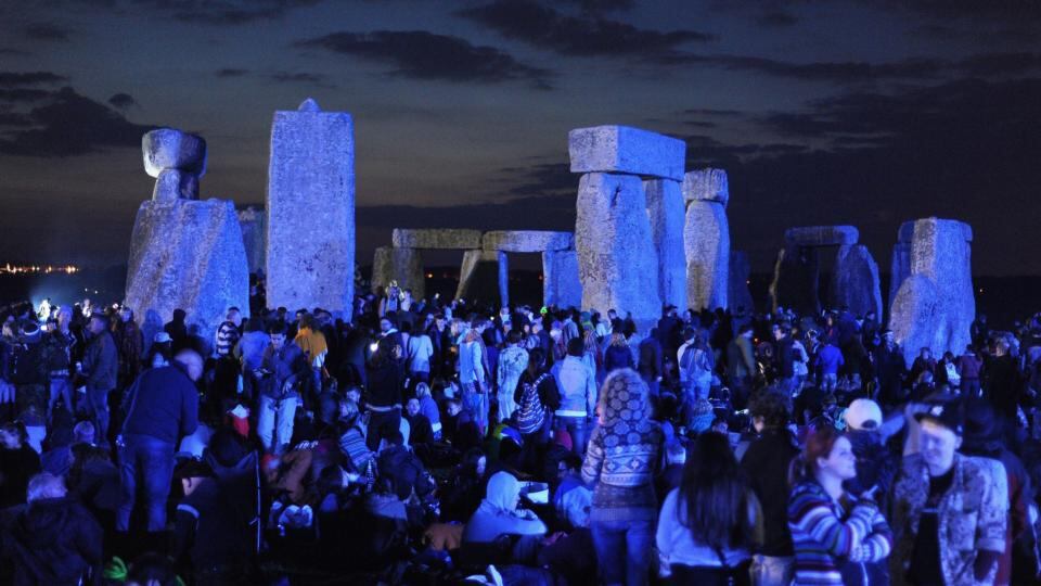 Crowds gather before dawn amongst the stones at Stonehenge in Wiltshire. Photograph: Andrew Matthews/PA Wire