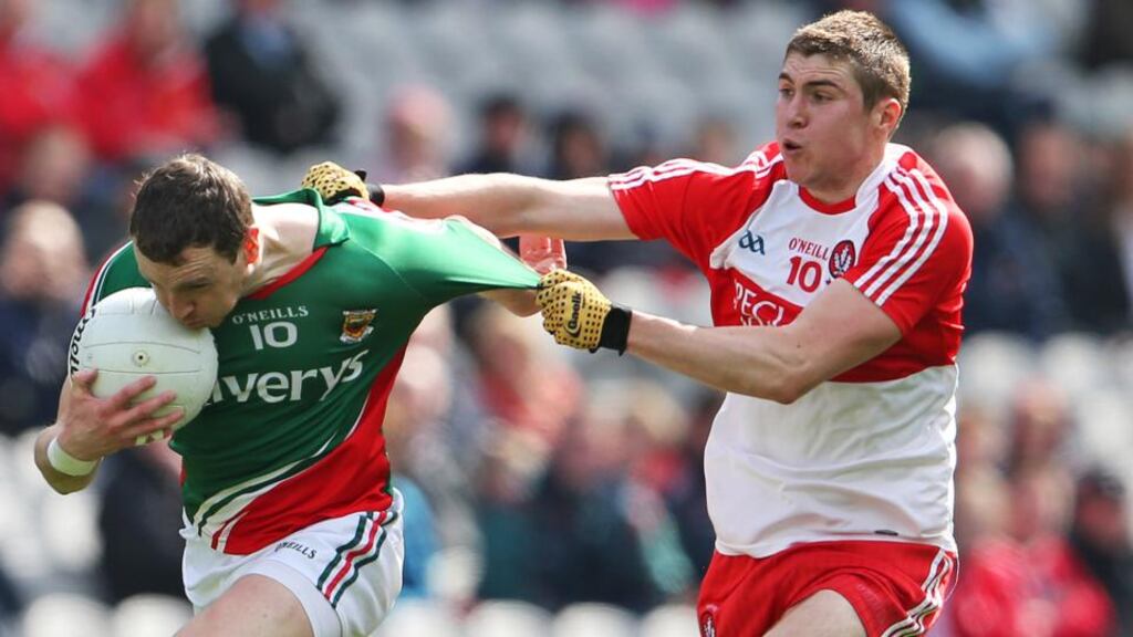 Keith Higgins struggles to escape Derry’s Ciaran McFaul