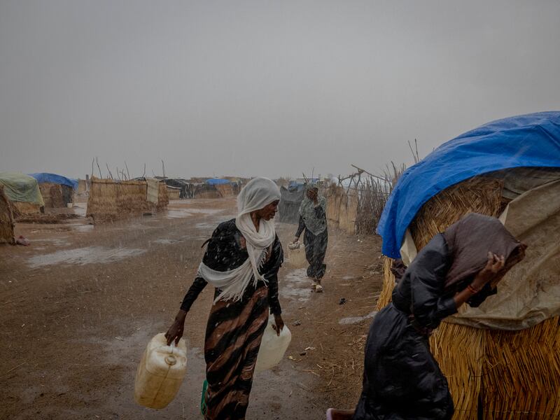 A downpour marks the start of the rainy season in a refugee camp that is home to the more than 150,000 people who have fled the civil war in Sudan, in Adre, Chad. Photograph: Ivor Prickett/New York Times
