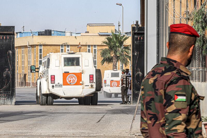 A Palestinian policeman loyal to Hamas looks on as a vehicle of the Multinational Force and Observers crosses towards the Egyptian side of the Rafah border crossing in the southern Gaza Strip in June. Photograph: Said Khatib/AFP via Getty Images