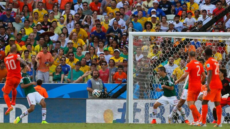 Wesley Sneijder (left) of the Netherlands scores the  equalizer against Mexico at the Estadio Castelao in Fortalez. Photograph: EPA