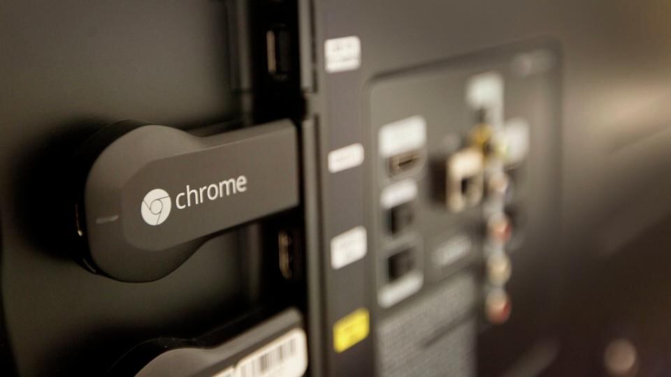 The new Google ChromeCast connected to the the back of a television. Photograph: Tony Avelar/Bloomberg