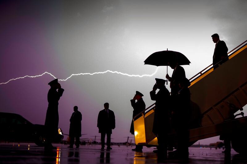 Tempestuous presidency: lightning streaks across the sky as Donald Trump walks off Air Force One in 2020. Photograph: Doug Mills/New York Times