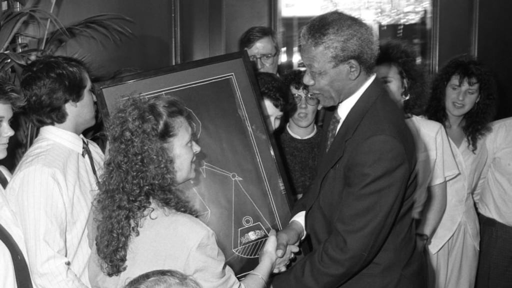 Cathryn O’Reilly, one of the Dunnes Stores strikers, presenting Nelson Mandela with an original Robert Ballagh print in Dublin. Photograph: Frank Miller