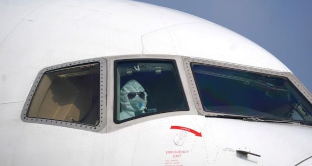 A pilot wearing a protective suit parks a cargo aircraft at Wuhan Tianhe International Airport. Photograph: Cheng Min/Xinhua via AP