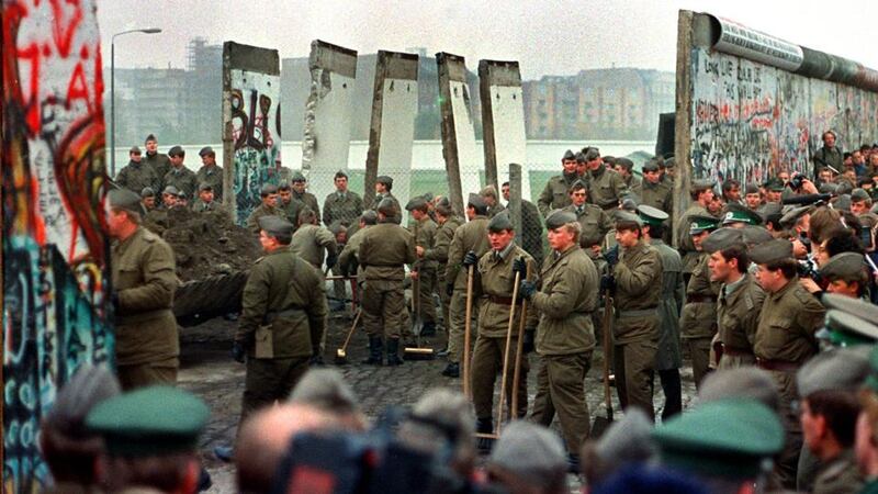 Influence: soldiers remove some of the first sections of the Berlin Wall at Potsdamer Platz, in November 1989; after Ireland organised two summits on German reunification, Gerry Collins was invited as the first foreign minister to visit East Germany after the fall of the wall. Photograph: John Tlumacki/Boston Globe via Getty