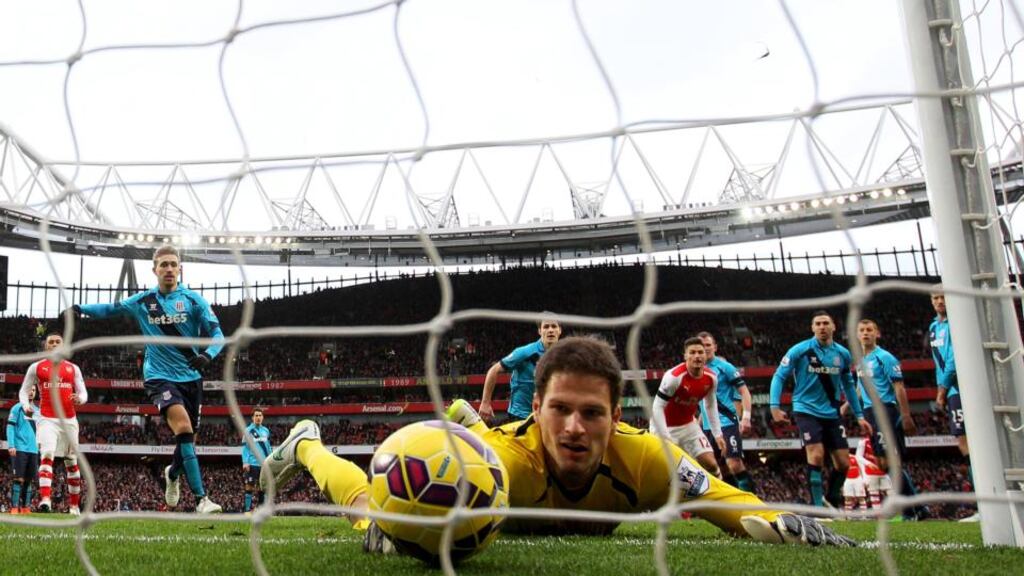 Asmir Begovic of Stoke City fails to stop the ball crossing the line as Alexis Sanchez (not pictured) of Arsenal scores his team’s third goal from a free-kick at Emirates Stadium. Photograph: Clive Rose/Getty Images