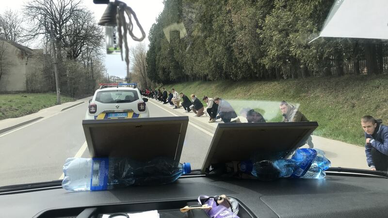 A hearse carries the body of Ivan Myno: ‘Lots of people knelt on the roadside in the falling snow as we passed. They came out to honour a hero.’ Photograph: Yaryna Chuchman