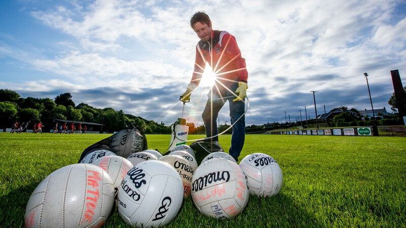 Mattock Rangers club secretary and Covid officer Earnan Roche sanities footballs as players return to training after Covid-19 restrictions were eased by the GAA. Photograph: Morgan Treacy/Inpho