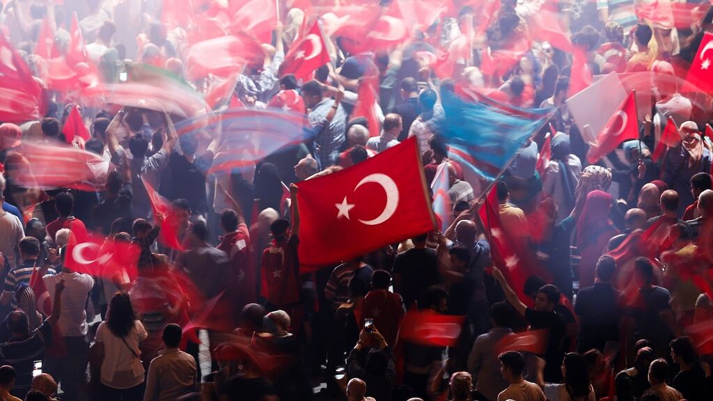 Supporters of Turkish President Tayyip Erdogan flock to the national standard during a pro-government demonstration on Taksim square in Istanbul, Turkey. Photograph: Reuters