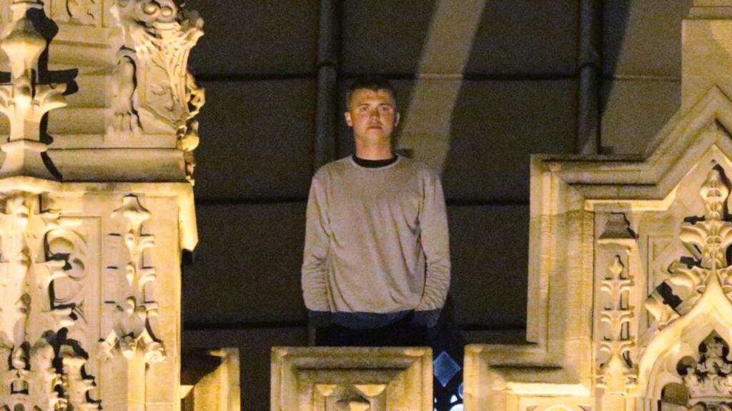 An unidentified man stands on the roof of the Palace of Westminster in central London. He has been arrested on suspicion of criminal damage and trespassing. Photograph: Yui Mok/PA Wire