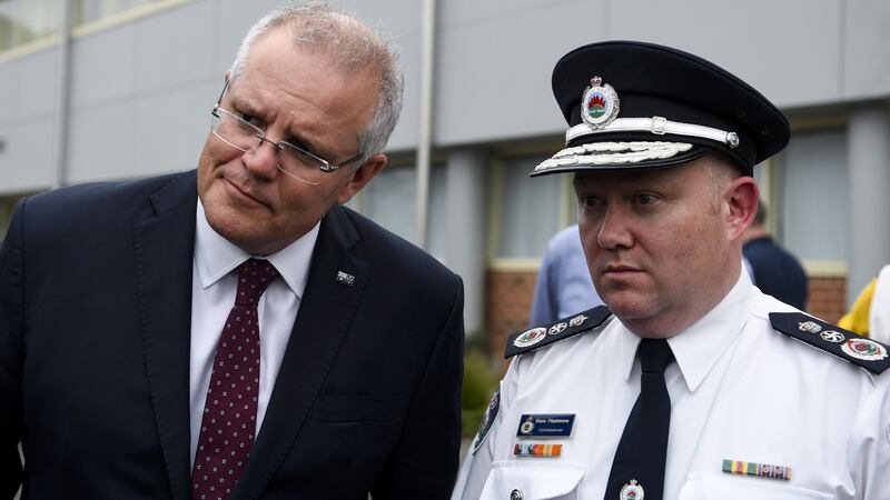 Australian Prime Minister Scott Morrison and New South Wales Rural Fire Service Commissioner Shane Fitzsimmons visit HMAS Albatross in Nowra, New South Wales, on Sunday. Photograph: Lukas Coch/EPA
