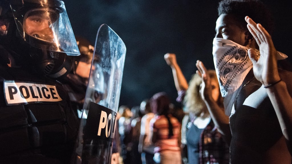 Police officers face off with protesters following the death of a man shot by a police officer in Charlotte. Photograph: Sean Rayford/Getty Images