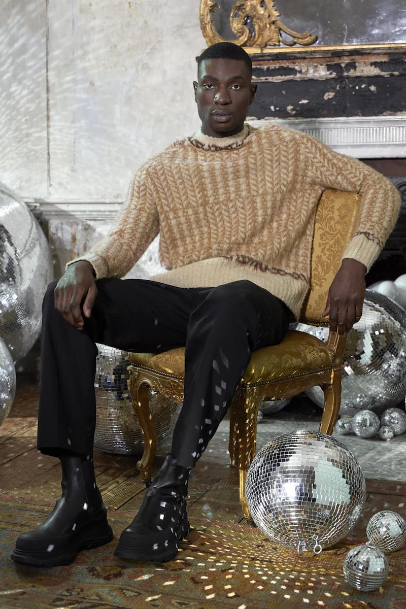 Knit sweater €330 Acne Studios, trousers €499 Loewe, boots €850 Alexander McQueen