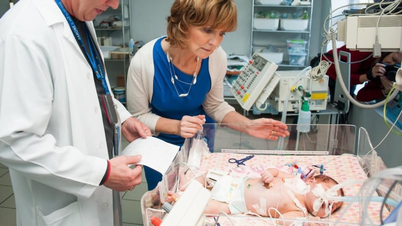 Adi Roche with a child after life-saving operation in Kharkiv.