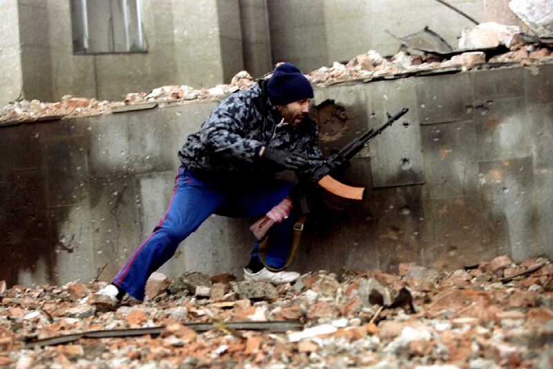 A Chechen fighter moves into firing position next to the Presidential Palace in central Grozny during heavy fighting in January 1995. Photograph: Reuters