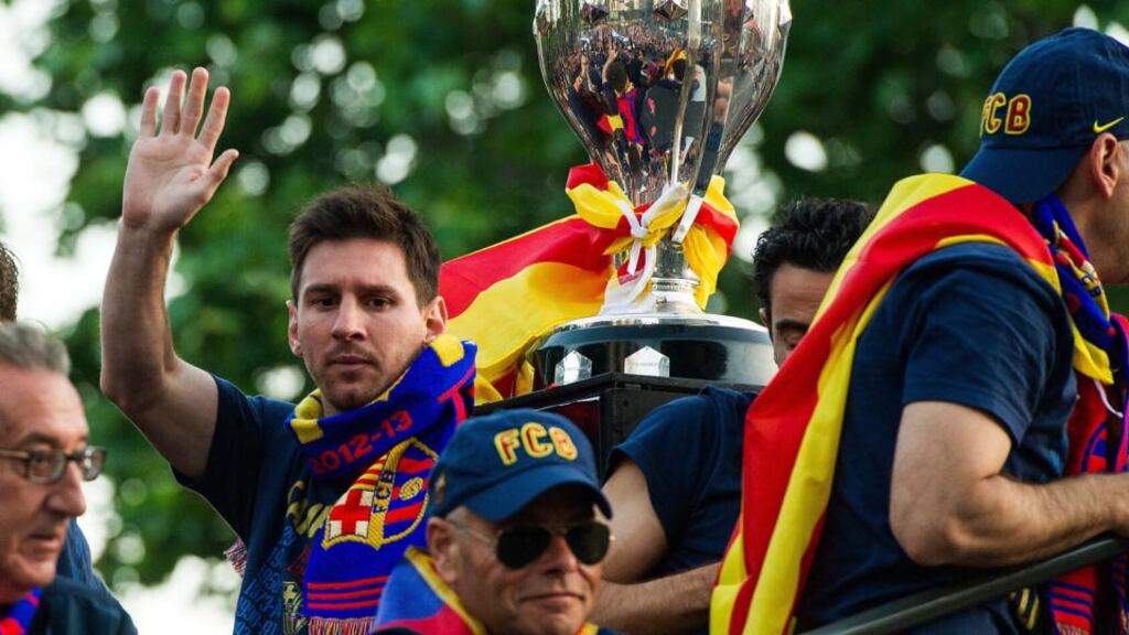 Lionel Messi waves to the crowds during Barcelona’s victory parade in the city on Monday. Photograph:   David Ramos/Getty Images