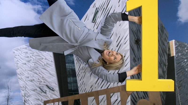 Fiona Cunningham of Tourism NI hangs on to Titanic Belfast for dear life at a display in Dublin.