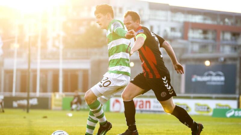 Trevor Clarke and Derek Pender tussle for the ball at Tallaght Stadium. Photograph: Inpho