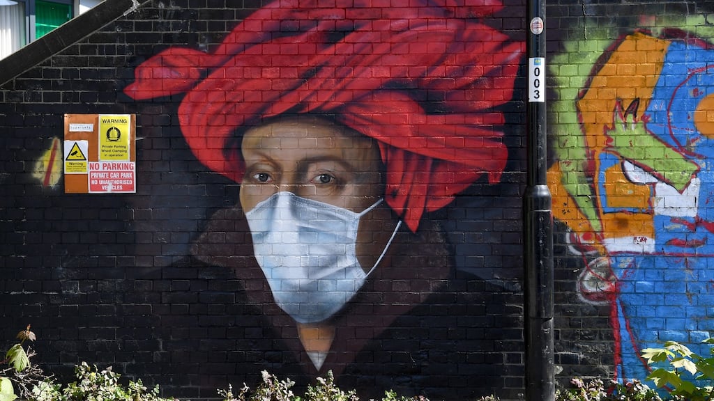 A mural by street artist Lionel Stanhope depicts a painting by Jan van Eyck wearing a protective face mask in south London last year. Photograph: EPA/Facundo Arrizabalaga