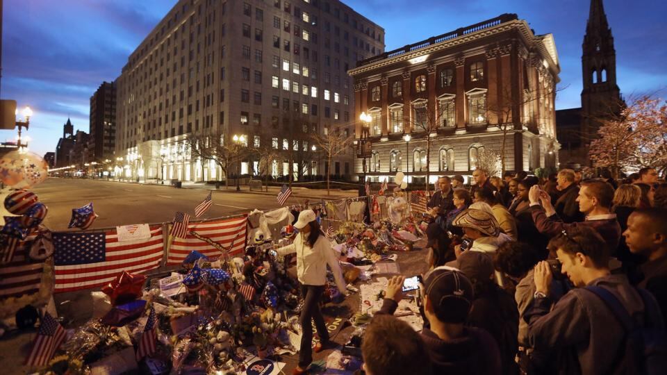 People gather at a makeshift memorial for victims near the site of the Boston Marathon bombings at the edge of the still-closed section of Boylston Street last night. Photograph:  Mario Tama/Getty Images