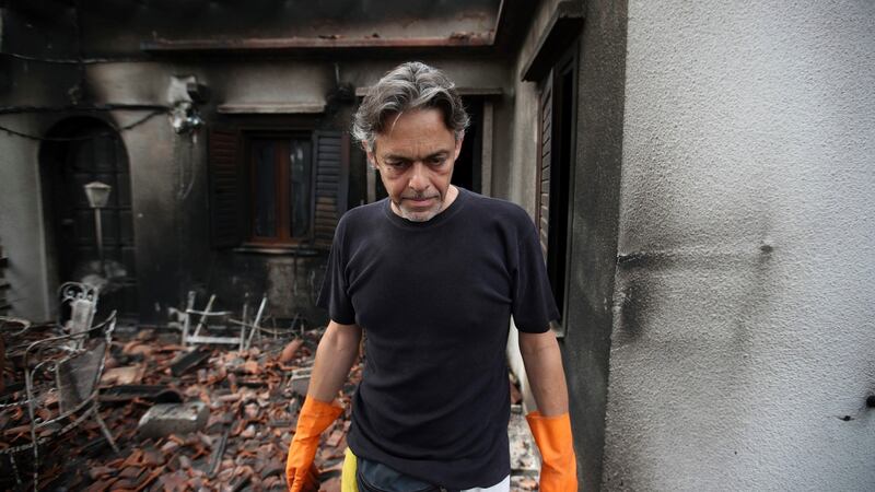 Girogos Handrinos stands outside his burned house in Mati, east of Athens, on Thursday. Photograph: Thanassis Stavrakis/AP