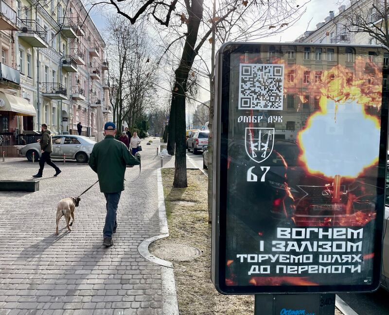 A military recruiting poster in Kyiv which reads: 'With fire and iron we pave the way to victory.' Photograph: Daniel McLaughlin