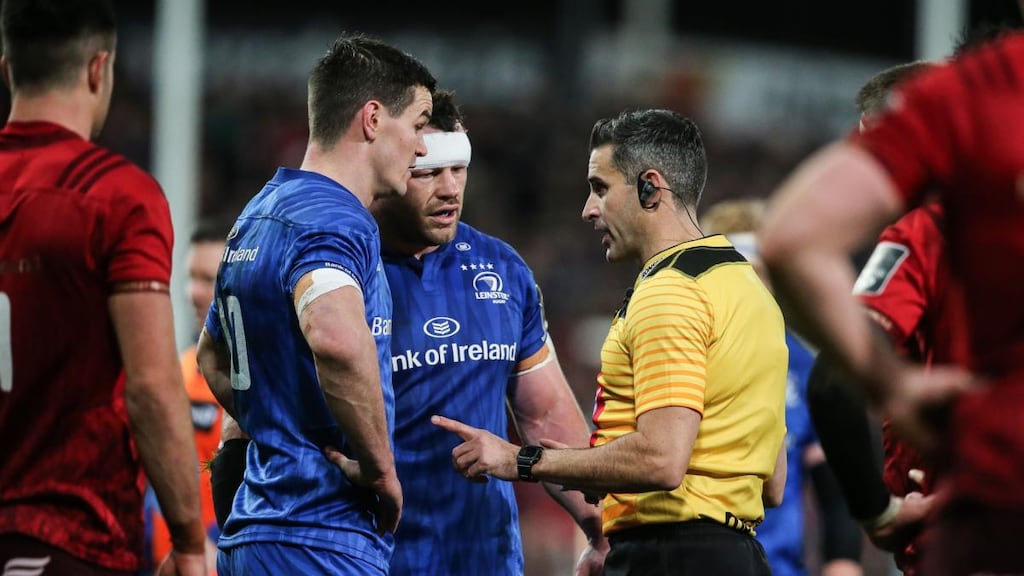 Referee Frank Murphy speaks to Johnny Sexton and Cian Healy during Leinster’s defeat to Munster. Photograph: Gary Carr/Inpho