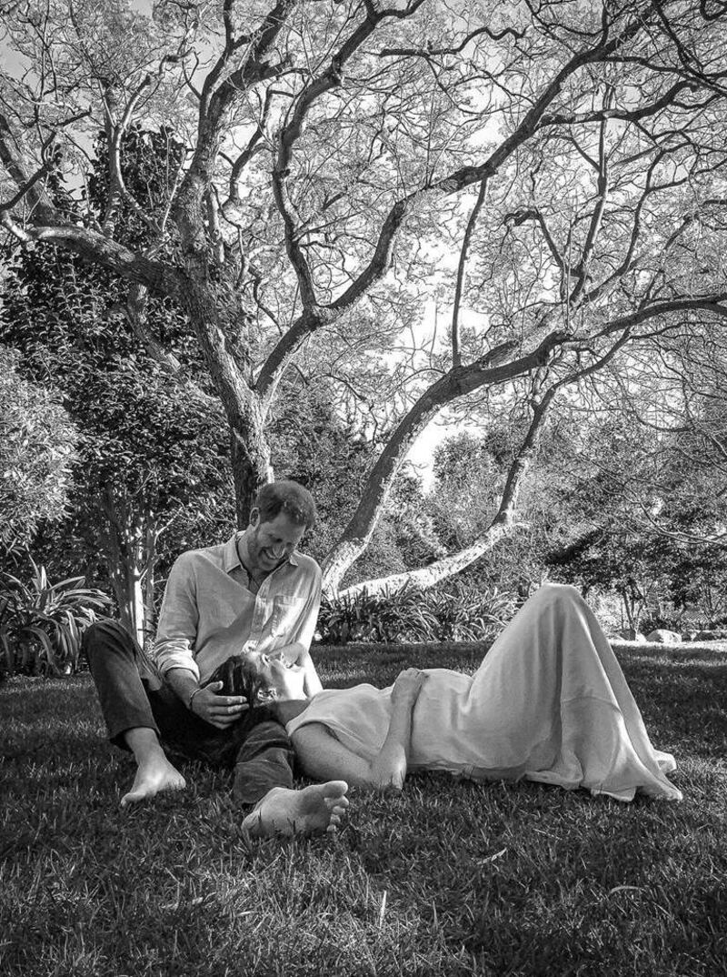 Harry and Meghan Markel sit together under a tree in an image released to announce that they are expecting another child. Photograph: Misan Harriman/The Duke and Duchess of Sussex via Getty Images/handout