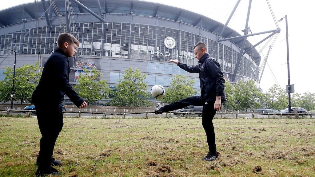 Jack (right) and Jaydan Silgran play football outside the Etihad Stadium ahead of Wednesday’s Premier League restart. Photograph: Martin Rickett/PA Wire